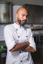 Portrait of a professional chef standing confidently in a modern kitchen setting.